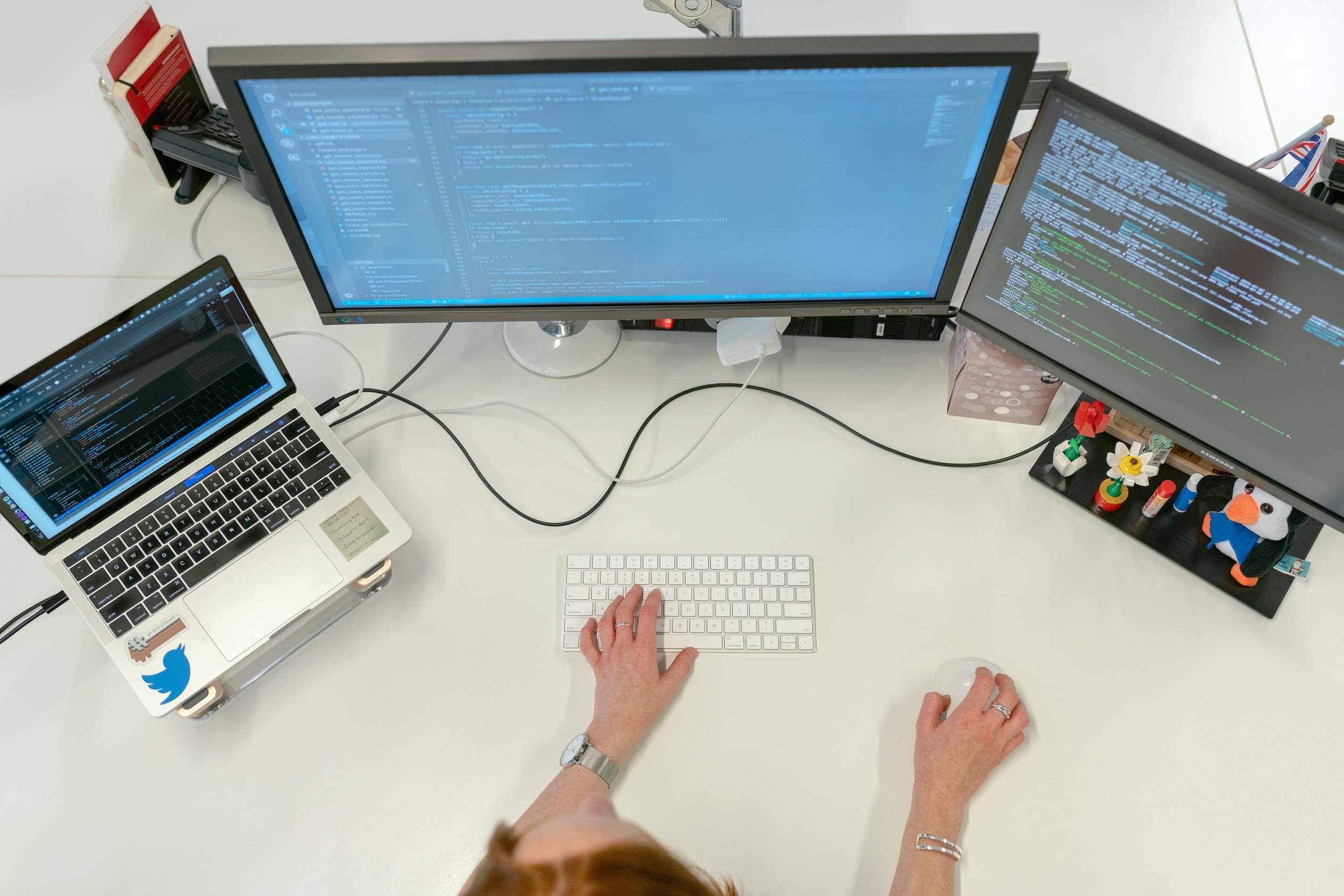 Developer hands on a laptop with code on screen during a security review
